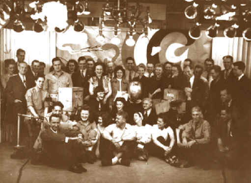 The staff of W9XBK pose for this undated 1940s photo as Belulah Zachary is presented with her first "Beulah Aig".